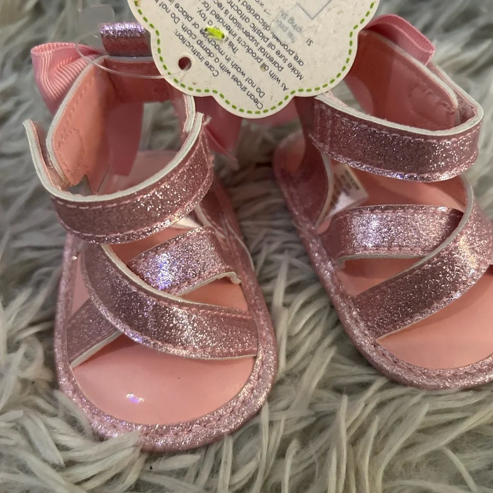 New with tags “First steps” Glittery Pink Kids Sandals. Size 1.